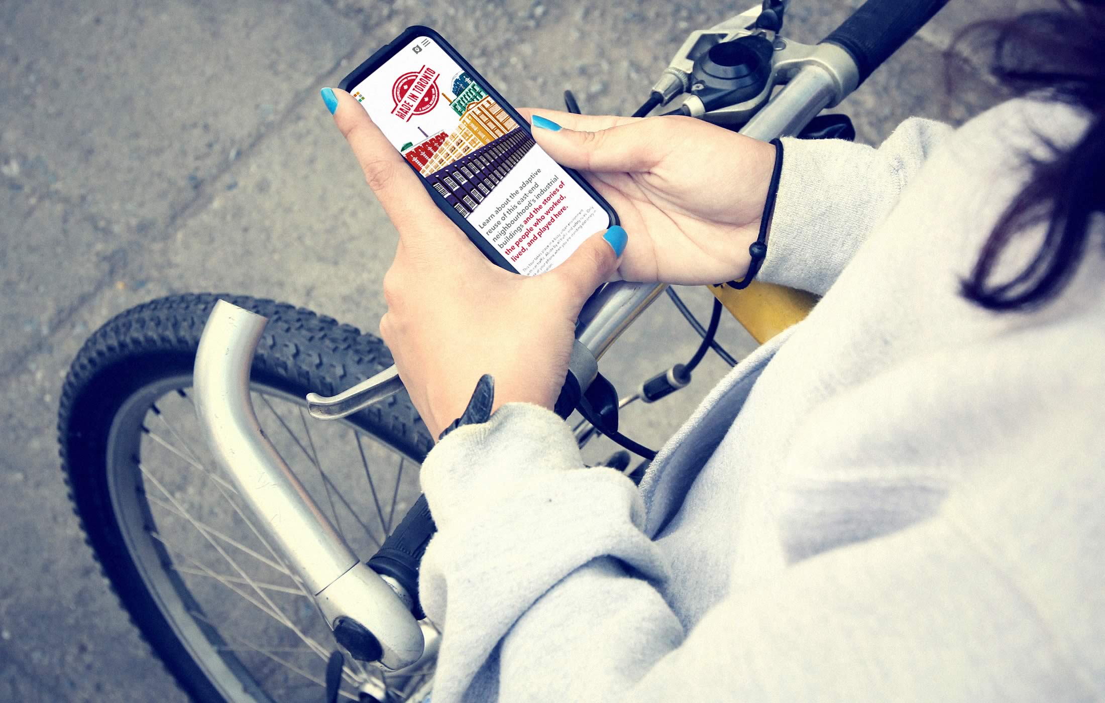 Closeup of a person interacting with the Made in Toronto tour/website on their mobile phone
